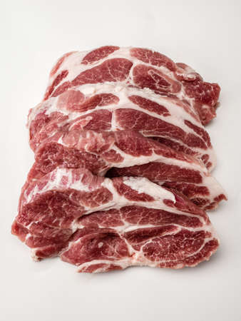Close up of raw fresh pork steaks. raw meat. fresh raw beef lamb. cooking meat on white. Butchery, market, shop. Sliced raw pork meat. image for Butchery, butcher shop. verticalの写真素材