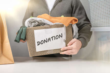 Donation concept. Donation box with donation clothes. Helping poor and needy people. Donation box...