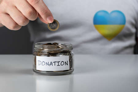 Donation for Ukraine concept. Help and financial assistance to Ukraine. donation jar with Ukrainian flag. donation for ukrainian refugees. Donation for Ukraine concept.の写真素材