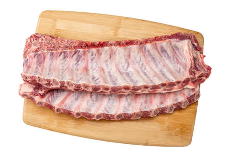 Raw pork spare loin ribs St Louis cut offered. closeup top view on wooden board. Racks of fresh raw pork meat ribs isolated on white backgroundの写真素材