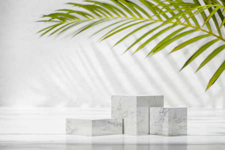 background for cosmetic products, skin care cosmetics, creams. three marble cubes of different sizes...