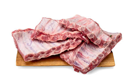 pieces of pork ribs isolated on board white background. Racks of fresh raw pork meat ribs isolated...