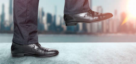 Motivation and challenge. Steps Forward to Success. Low Section of Businessman Walking Up on Staircase. Man takes step in classic shoesの写真素材