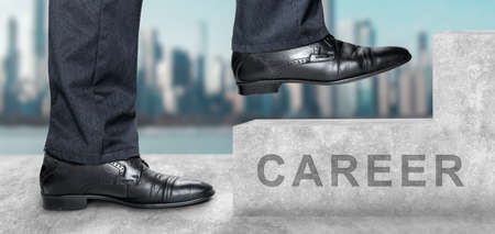 Side view of man climbing concrete stairs with career text. sky and city are in the background....