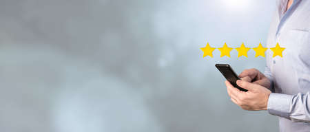Customer hand touching to phone 5 stars virtual screening monitor for satisfaction evaluation survey...