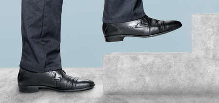 Side view of man climbing concrete stairs. Concept of success and achieving your goal. Steps Forward...
