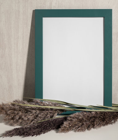 Green Frame mock up and dried natural pampas grass. interior decoration element. Flat lay top view. background boho. minimalist design. copyspace. vertical imageの写真素材