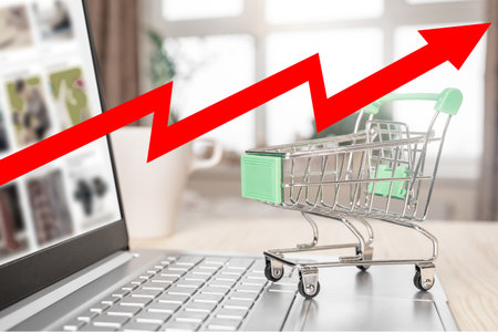 Inflation and economic crisis. Red arrow on chart, shopping cart and laptop. high inflation rate....
