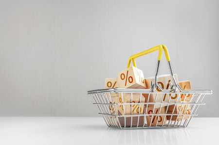 Advertisement, sale announcement. Shopping basket and boxes with sign discount percent. Sale Black Friday products on gray background. Concept of sell or buy with copy spaceの写真素材