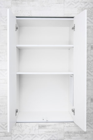 Mockup Empty white open cabinet with shelves in bathroom. shelves for product display, clean white cabinet, light gray wall paint, white wood. vertical imageの写真素材