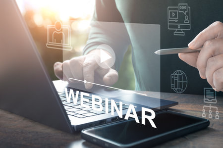 webinars online. Hand use stylus Browsing webinar on laptop. Virtual learning concept. hand typing on laptop keyboard with Webinar homepage. online educationの写真素材