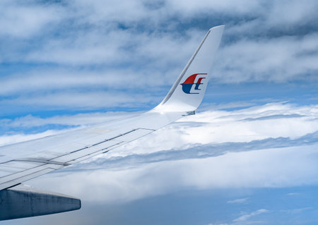 Kuala Lumpur, Malaysia - 22 February 2023: wing of malaysian airlines aircraft in flight. Malaysia Airlines, is the flag carrier airline of Malaysia. Wing of Boeing 737-800のeditorial素材