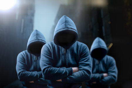 Dangerous criminal. Silhouette of bandits, criminals with an unrecognizable face in threatening pose at night on dark street. Frightening dangerous silhouettes of men. threatening rise in crimeの写真素材