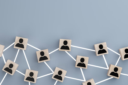Connecting people partnership or person above social media networks on concept using wooden cube block on blue background. Digital communication and technology conceptの写真素材