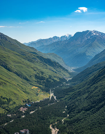 mountain valley between high mountains in summer. Panorama mountain summer landscape. summer mountain landscape. Beautiful landscape with high mountains, blue sky. Amazing scene with mountainsの写真素材