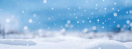 Empty panoramic winter background. Christmas blue background with snow. beautiful bokeh circles. New year Winter art design, wide screen holiday border abstract winter background with snowflakes.の素材