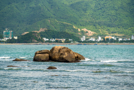 Nha Trang Vietnamese resort coastline is revealed in vibrant spectacle. picturesque rocky coast meet azure sea under radiant sun, panorama of beaches and crystal-clear watersの写真素材