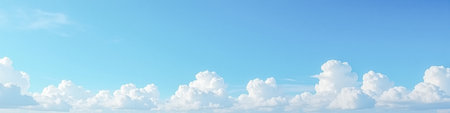 Expansive blue sky with soft white cumulus clouds spread across horizon, perfect for peaceful...