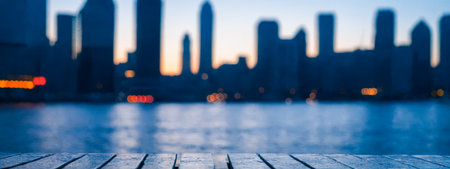 Atmospheric Night Cityscape Blur with Bright Lights, Merchandise Presentation, Evening Urban Skyline Out of Focus with Prominent Wooden Surface in Foreground, Commercial Useの素材