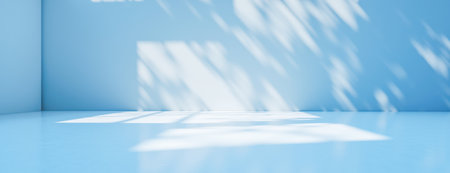 Bright, empty blue space with soft sunlight creating playful abstract shadows on smooth walls. Minimalist room design for showcasing products, art, or presentations. Calm, clean backgroundの写真素材