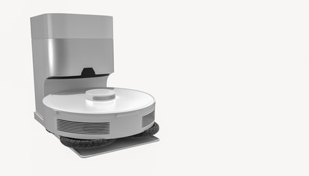 Robotic vacuum cleaner in charging dock on white background, smart home cleaning device, modern household appliance, automatic floor cleaner, home cleaning equipmentの写真素材