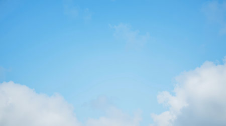Bright sunny sky background with scattered white clouds in daylight clear space ideal for web design template advertisement banner nature scene environmentの写真素材