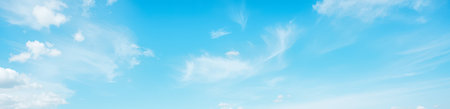 Panorama of peaceful blue sky with high cirrus clouds, sunlight, fresh air, banners, advertising, web headers, minimal backgrounds, natural beautyの写真素材