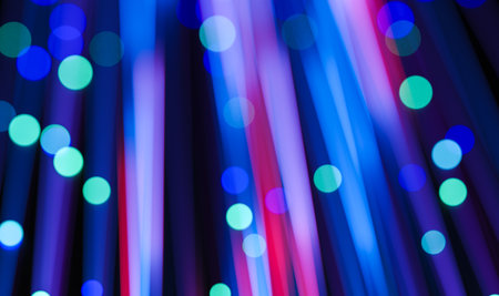 Glowing motion light trails with neon blue and pink tones and bokeh dots effect, suitable for futuristic screens or visual presentationsの写真素材