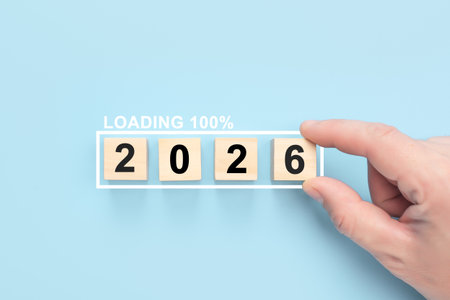 Male hand completes 2026 number with loading bar at 100 percent. Illustrates countdown, new beginnings, starting business projects, and future plansの写真素材