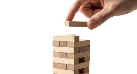 Person building tall structure with wood blocks representing construction or development, business strategy and risk theme, concept of planning, stability, foundation and completing projectの写真素材