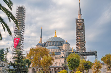 Sultan Ahmed Mosque, iconic Blue Mosque, with minarets in scaffolding for restoration. Turkish flag hanging on construction. Travel conceptの写真素材