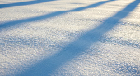 Fresh clean snow surface with shadow pattern in sunlight. Abstract background for christmas, holiday, or simple nature wallpaperの写真素材