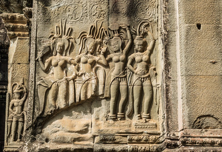 Ancient architecture theme featuring detail of artistic religious sculpture of celestial maiden on...