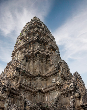 Architectural travel theme depicting summit of iconic Khmer empire monument with weathered texture and details at archaeological park in Asia Siem Reap Cambodiaの写真素材