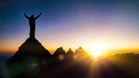 Male climber celebrating victory on top of rock suitable for travel adventure or extreme sport motivation concepts and freedom lifestyleの写真素材
