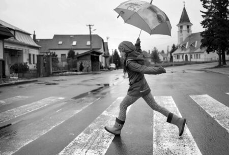 Girl with umbrella on Abbey road in Strbaの写真素材