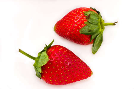 Berries of a ripe red strawberry on a white backgroundの写真素材