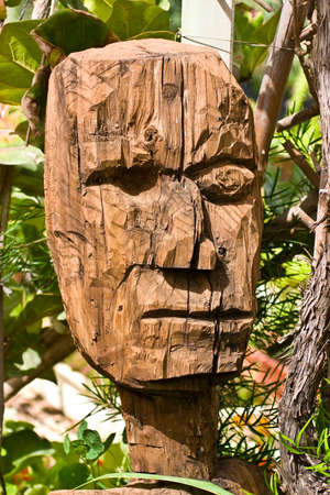 aging wooden sculpture in rift, decoration of the floral gardenの写真素材
