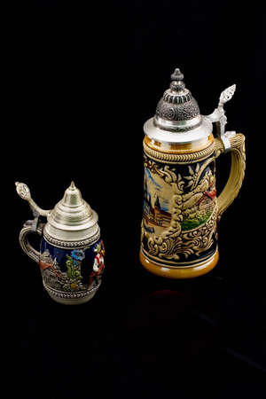 ceramic decorative beer mugs on black backgroundの写真素材