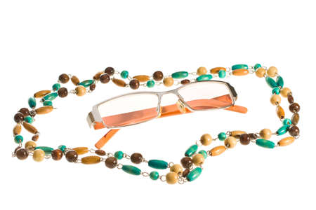 Sunglasses and beads on a white backgroundの写真素材