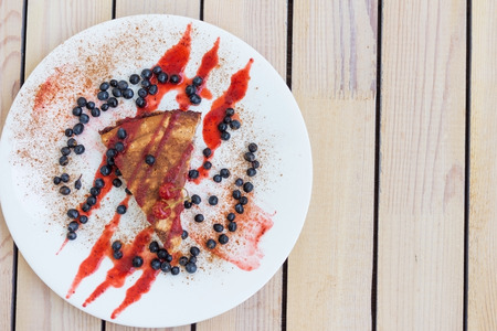 cherry pie with blueberries. on a plate with a wooden backgroundの写真素材