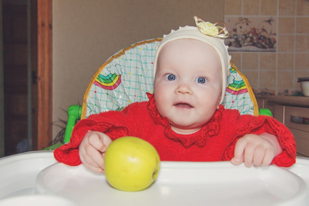 a small child with an appleの写真素材