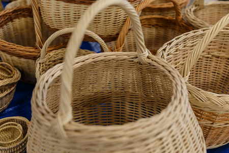 yellow wicker baskets for sale in a shopの写真素材