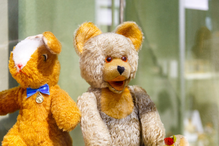 Beautiful teddy bears from around the world stand on the shelf in a toy storeの写真素材