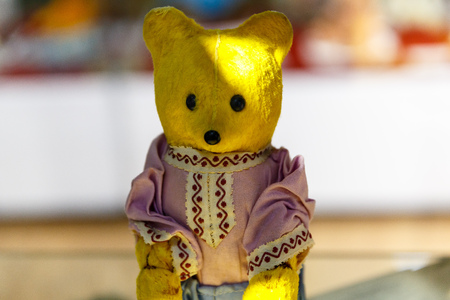 Beautiful teddy bears from around the world stand on the shelf in a toy storeの写真素材
