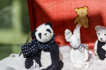 Beautiful teddy bears from around the world stand on the shelf in a toy storeの写真素材