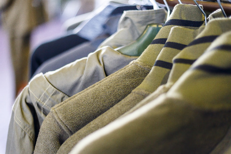 Hunting jackets and clothes hang on shelves in a hunting and fishing storeの写真素材