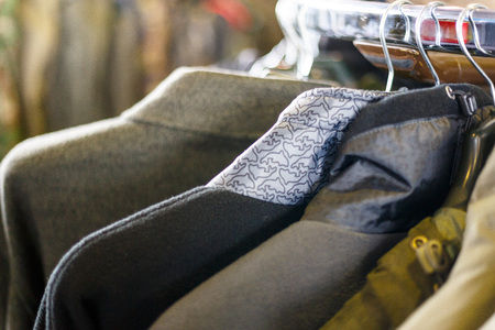 Hunting jackets and clothes hang on shelves in a hunting and fishing store