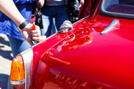 The man put his hand on the surface of a retro or classic carの写真素材