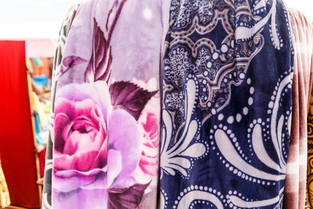 Wool blankets and plaids on the stand in the bed-clothes storeの写真素材